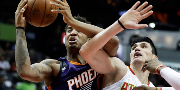 Phoenix Suns' Marquese Chriss, left, grabs a rebound from Atlanta Hawks' Ersan Ilyasova, of Turkey,...