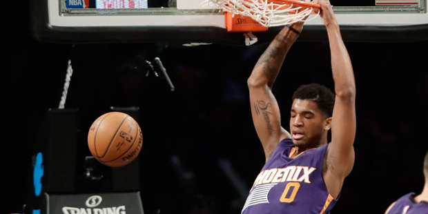 Phoenix Suns' Marquese Chriss (0) dunks in front of Brooklyn Nets' Quincy Acy, left, and Spencer Di...