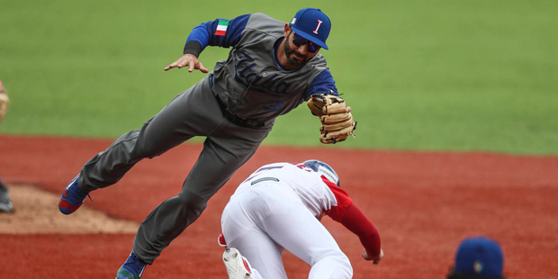 Italy's catcher Daniel Descalso, left, tags out Kike Hernandez of Venezuela during a World Baseball...