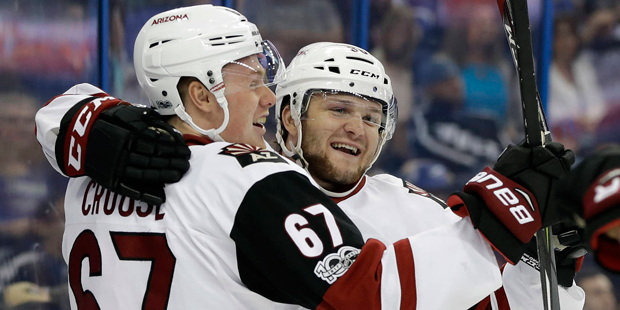 Arizona Coyotes right wing Christian Fischer (36) celebrates with left wing Lawson Crouse (67) afte...