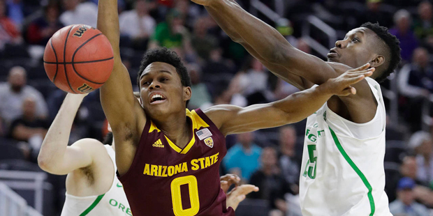Oregon's Chris Boucher, right, fouls Arizona State's Tra Holder during the second half of an NCAA c...