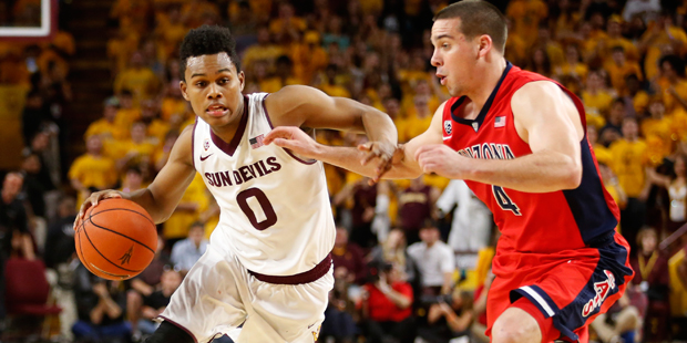 Arizona State guard Tra Holder (0) drives on Arizona guard T.J. McConnell during the second half of...