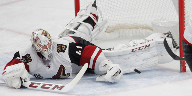 Arizona Coyotes goalie Mike Smith (41) makes a pad save during the third period of an NHL hockey ga...