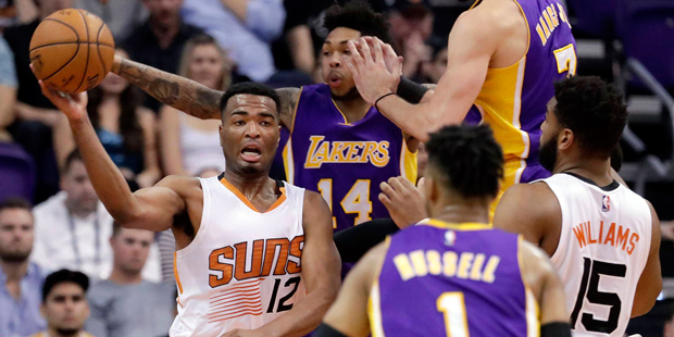 Phoenix Suns forward TJ Warren (12) passes the ball away from Los Angeles Lakers forward Brandon In...