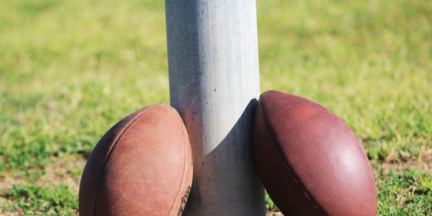 Two footballs sit on a field-goal post at Basha High School in Chandler, Ariz. (Photo by Tyler Drak...