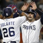 San Diego Padres' Yangervis Solarte, left, and Austin Hedges congratulate each other for scoring on a two-run double by Erick Aybar against the Arizona Diamondbacks during the fifth inning of a baseball game in San Diego, Thursday, April 20, 2017. (AP Photo/Alex Gallardo)