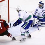 Arizona Coyotes' Alexander Burmistrov (91) beats Vancouver Canucks' Christopher Tanev (8) and Ryan Miller (30) for a goal during the second period of an NHL hockey game Thursday, April 6, 2017, in Glendale, Ariz. (AP Photo/Ross D. Franklin)