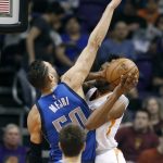 Dallas Mavericks center Salah Mejri (50) defends the shot of Phoenix Suns forward Derrick Jones Jr., right, during the first half of an NBA basketball game, Sunday, April 9, 2017, in Phoenix. (AP Photo/Ralph Freso)
