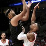 Phoenix Suns forward Jared Dudley shoots over Portland Trail Blazers guard Damian Lillard during the first quarter of an NBA basketball game in Portland, Ore., Saturday, April 1, 2017. (AP Photo/Steve Dykes)