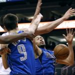 Dallas Mavericks center A.J. Hammons, right, battles for a rebound under the basket with the Mavericks' Nicolas Brussino (9) and Phoenix Suns' Alex Len during the second half of an NBA basketball game, Sunday, April 9, 2017, in Phoenix. The Suns defeated the Mavericks 124-111. (AP Photo/Ralph Freso)