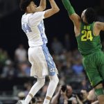 North Carolina forward Justin Jackson, left, shoots over Oregon forward Dillon Brooks during the first half in the semifinals of the Final Four NCAA college basketball tournament, Saturday, April 1, 2017, in Glendale, Ariz. (AP Photo/David J. Phillip)