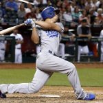 Los Angeles Dodgers' Corey Seager follows through on his swing for a run-scoring single against the Arizona Diamondbacks during the fifth inning of a baseball game Friday, April 21, 2017, in Phoenix. (AP Photo/Ross D. Franklin)
