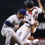 Arizona Diamondbacks' A.J. Pollock, right, beats the throw down to second base as San Diego Padres' Cory Spangenberg applies a late tag during the first inning of a baseball game Wednesday, April 26, 2017, in Phoenix. Pollock was awarded second base on the play on a ball four issued to Diamondbacks' David Peralta. (AP Photo/Ross D. Franklin)