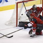 Arizona Coyotes' Mike Smith, right, slides over the make a save on a shot from Minnesota Wild's Matt Dumba (24) as Coyotes' Connor Murphy (5) helps out during the first period of an NHL hockey game Saturday, April 8, 2017, in Glendale, Ariz. (AP Photo/Ross D. Franklin)