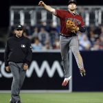 Arizona Diamondbacks second baseman Brandon Drury, right, leaps to throw to first, with second base umpire Pat Hoberg watching, but not in time to get San Diego Padres' Manuel Margot during the eighth inning of a baseball game in San Diego, Wednesday, April 19, 2017. (AP Photo/Alex Gallardo)
