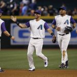 Arizona Diamondbacks' Chris Owings (16) celebrates the team's 6-2 win against the San Diego Padres with David Peralta, second from left, Yasmany Tomas, second from right, and A.J. Pollock, after a baseball game Thursday, April 27, 2017, in Phoenix. (AP Photo/Ross D. Franklin)