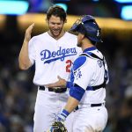 Los Angeles Dodgers starting pitcher Clayton Kershaw, left, and catcher Yasmani Grandal congratulate each other after the Dodgers defeated the Arizona Diamondbacks 7-1 in a baseball game, Friday, April 14, 2017, in Los Angeles. (AP Photo/Mark J. Terrill)