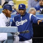 Los Angeles Dodgers manager Dave Roberts, right, talks with Justin Turner in the dugout during the eighth inning of a baseball game against the Arizona Diamondbacks, Friday, April 14, 2017, in Los Angeles. (AP Photo/Mark J. Terrill)