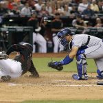 Arizona Diamondbacks' Robbie Ray, second from left, is tagged out by Los Angeles Dodgers catcher Austin Barnes, right, as he tries to score on a fielder's choice ground ball by teammate David Peralta during the second inning of a baseball game, Saturday, April 22, 2017, in Phoenix. (AP Photo/Ralph Freso)