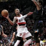 Portland Trail Blazers guard Damian Lillard passes the ball as he drives against Phoenix Suns forward Marquese Chriss during the second half of an NBA basketball game in Portland, Ore., Saturday, April 1, 2017. The Blazers won 130-117. (AP Photo/Steve Dykes)