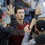 Arizona Diamondbacks' Nick Ahmed, center, is congratulated by teammates in the dugout after hitting a three-run home run during the second inning of a baseball game against the Los Angeles Dodgers, Saturday, April 15, 2017, in Los Angeles. (AP Photo/Jae C. Hong)