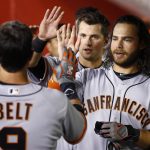 San Francisco Giants' Brandon Belt, left, celebrates his home run against the Arizona Diamondbacks with Brandon Crawford, right, and Joe Panik during the fifth inning of a baseball game Wednesday, April 5, 2017, in Phoenix. (AP Photo/Ross D. Franklin)