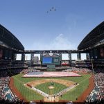 Players and coaches from the Arizona Diamondbacks and the San Francisco Giants stand for the national anthem as jets from Luke Air Force Base fly over prior to an Opening Day baseball game Sunday, April 2, 2017, in Phoenix. (AP Photo/Ross D. Franklin)