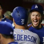 Los Angeles Dodgers' Joc Pederson (31) celebrates his run scored against the Arizona Diamondbacks with teammates, including Clayton Kershaw, right, in the dugout during the fifth inning of a baseball game Friday, April 21, 2017, in Phoenix. (AP Photo/Ross D. Franklin)
