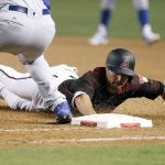 Arizona Diamondbacks' A.J. Pollock, right, dives safely back to first around Los Angeles Dodgers' Scott Van Slyke on a pick-off attempt during the eighth inning of a baseball game, Saturday, April 22, 2017, in Phoenix. (AP Photo/Ralph Freso)