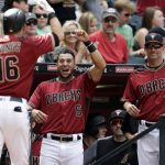 Arizona Diamondbacks' Chris Owings (16) celebrates with David Peralta (6) and manager Torey Lovullo (17) after hitting a solo home run against the Cleveland Indians in the sixth inning of a baseball game, Sunday, April 9, 2017, in Phoenix. (AP Photo/Rick Scuteri)