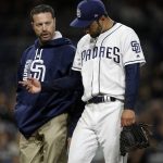 San Diego Padres trainer Mark Rogow, left, walks off the field with injured starting pitcher Jarred Cosart during the fourth inning of a baseball game against the Arizona Diamondbacks in San Diego, Tuesday, April 18, 2017. (AP Photo/Alex Gallardo)