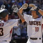 Arizona Diamondbacks' A.J. Pollock (11) celebrates his two-run home run against the San Francisco Giants with Nick Ahmed (13) during the sixth inning of an Opening Day baseball game Sunday, April 2, 2017, in Phoenix. (AP Photo/Ross D. Franklin)