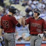 Arizona Diamondbacks' Nick Ahmed, right, is congratulated by Patrick Corbin after hitting a three-run home run during the second inning of a baseball game against the Los Angeles Dodgers, Saturday, April 15, 2017, in Los Angeles. (AP Photo/Jae C. Hong)