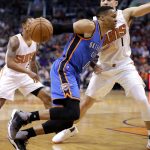 Oklahoma City Thunder guard Russell Westbrook (0) drives past Phoenix Suns guard Devin Booker (1) during the first half of an NBA basketball game, Friday, April 7, 2017, in Phoenix. (AP Photo/Matt York)