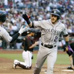 Colorado Rockies' Trevor Story (27) is congratulated by teammate Tony Wolters (14) after hitting a solo home run against the Arizona Diamondbacks during the third inning of a baseball game, Saturday, April 29, 2017, in Phoenix. (AP Photo/Ralph Freso)