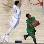 Oregon guard Dylan Ennis, right, drives to the basket ahead of North Carolina forward Justin Jackson, left, during the second half in the semifinals of the Final Four NCAA college basketball tournament, Saturday, April 1, 2017, in Glendale, Ariz. (AP Photo/David J. Phillip)