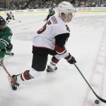 Arizona Coyotes defenseman Connor Murphy (5) takes control of the puck in front of Dallas Stars center Gemel Smith (46) during the second period of an NHL hockey game in Dallas, Tuesday, April 4, 2017. (AP Photo/LM Otero)