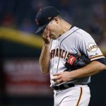 San Francisco Giants' Matt Moore wipes his face as he pauses on the mound on his way to giving up three runs during the fifth inning of the team's baseball game against the Arizona Diamondbacks on Wednesday, April 5, 2017, in Phoenix. (AP Photo/Ross D. Franklin)