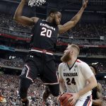 Gonzaga's Przemek Karnowski (24) tries to shoot against South Carolina's Justin McKie (20) during the first half in the semifinals of the Final Four NCAA college basketball tournament, Saturday, April 1, 2017, in Glendale, Ariz. (AP Photo/David J. Phillip)