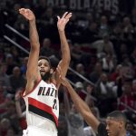 Portland Trail Blazers guard Allen Crabbe hits a 3-point shot over Minnesota Timberwolves guard Kris Dunn to give the Blazers the lead during the second half of an NBA basketball game in Portland, Ore., Thursday, April 6, 2017. Crabb scored 25 points as the Blazers won 105-98. (AP Photo/Steve Dykes)