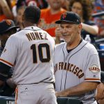 San Francisco Giants manager Bruce Bochy, right, smiles as he celebrates a run scored by Giants' Eduardo Nunez (10) during the second inning of a baseball game against the Arizona Diamondbacks on Wednesday, April 5, 2017, in Phoenix. (AP Photo/Ross D. Franklin)