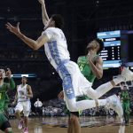 North Carolina forward Justin Jackson shoots over Oregon guard Tyler Dorsey, right, during the second half in the semifinals of the Final Four NCAA college basketball tournament, Saturday, April 1, 2017, in Glendale, Ariz. (AP Photo/David J. Phillip)
