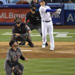 Los Angeles Dodgers' Enrique Hernandez, right, hits a solo home run as Arizona Diamondbacks starting pitcher Robbie Ray, lower left, catcher Jeff Mathis, second from left, and home plate umpire Stu Scheurwater watch during the fourth inning of a baseball game, Monday, April 17, 2017, in Los Angeles. (AP Photo/Mark J. Terrill)