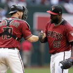 Arizona Diamondbacks relief pitcher Fernando Rodney (56) and Chris Herrmann celebrate after defeating the Cleveland Indians 3-2 in a baseball game, Sunday, April 9, 2017, in Phoenix. (AP Photo/Rick Scuteri)