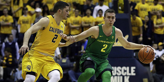 Oregon's Casey Benson, right, drives the ball against California's Sam Singer in the first half of ...