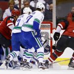 Arizona Coyotes' Luke Schenn (2) scores a goal as Vancouver Canucks' Ben Hutton (27), Sven Baertschi (47) and Coyotes' Brendan Perlini (29) look on during the first period of an NHL hockey game Thursday, April 6, 2017, in Glendale, Ariz. (AP Photo/Ross D. Franklin)