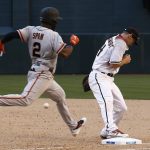 San Francisco Giants' Denard Span (2) stretches out to first base for a single as Arizona Diamondbacks' Paul Goldschmidt, right, misses the ball during the ninth inning of an Opening Day baseball game Sunday, April 2, 2017, in Phoenix. (AP Photo/Ross D. Franklin)