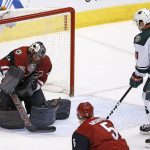 Arizona Coyotes' Mike Smith, left, makes a save on a shot from Minnesota Wild's Zach Parise (11) as Coyotes' Connor Murphy (5) looks on during the first period of an NHL hockey game Saturday, April 8, 2017, in Glendale, Ariz. (AP Photo/Ross D. Franklin)