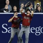 Arizona Diamondbacks right fielder David Peralta, right, catches a fly ball hit by San Diego Padres' Wil Myers with center fielder A.J. Pollock, left, watching during the first inning of a baseball game in San Diego, Wednesday, April 19, 2017. (AP Photo/Alex Gallardo)