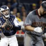 San Diego Padres catcher Austin Hedges, left, prepares to throw the ball to first to get Arizona Diamondbacks Paul Goldschmidt, after Goldschmidt struck out during the seventh inning of a baseball game in San Diego, Thursday, April 20, 2017. (AP Photo/Alex Gallardo)